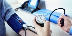 Doctor measuring blood pressure of patient